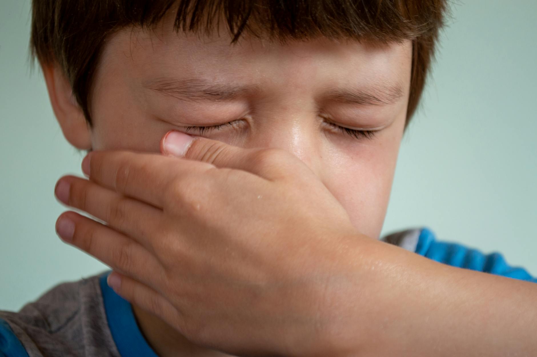 boy wiping his tears