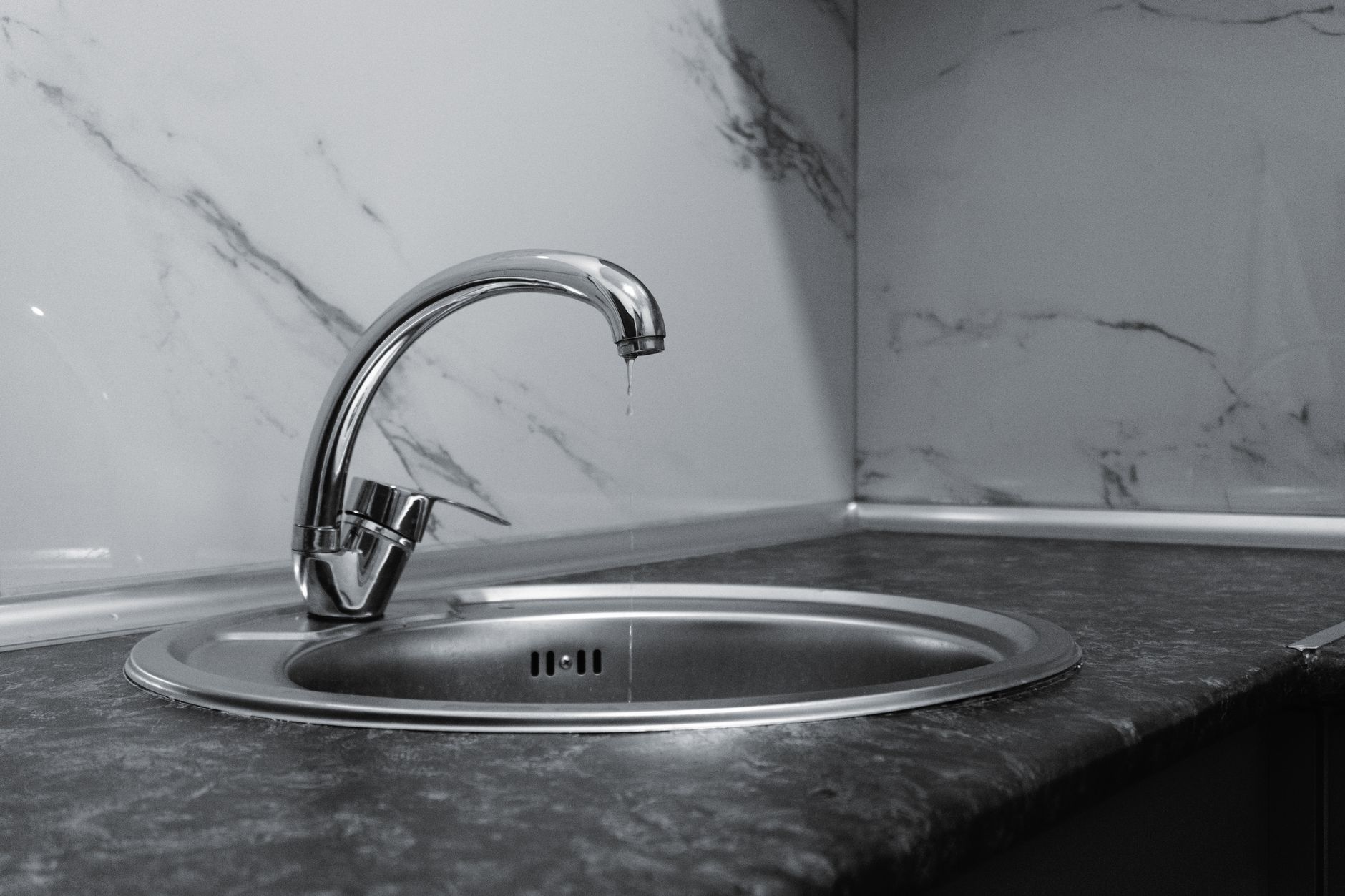 minimalist kitchen tap with dripping water
